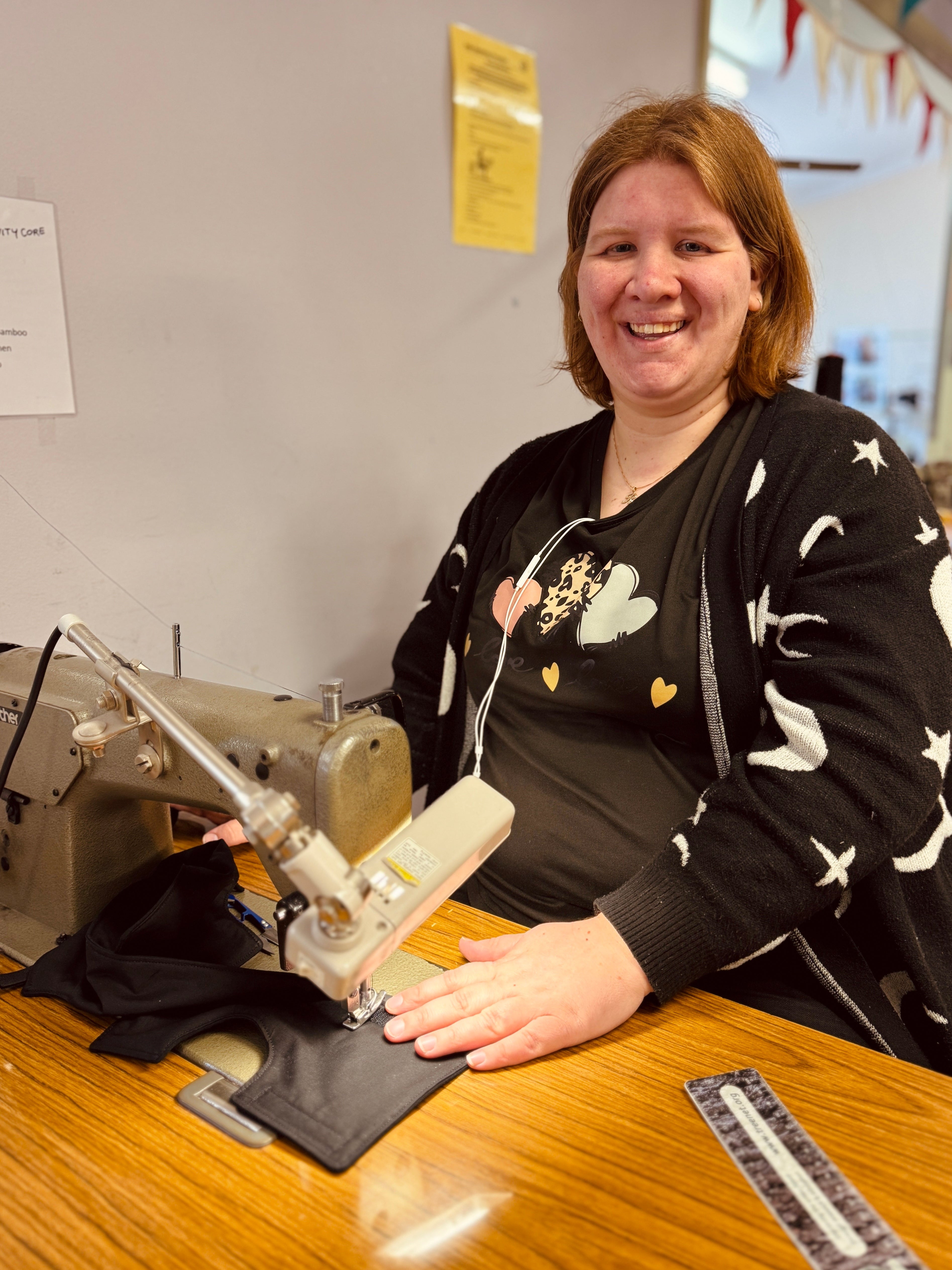 Woman sitting at a sewing machine at Mobo Group