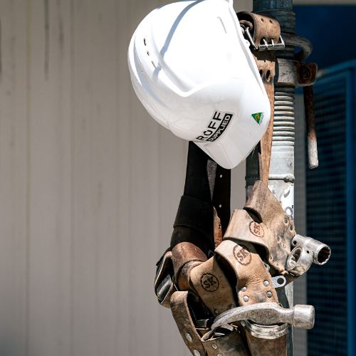 Ruff Supplied hard hat hanging with a tradie toolbelt